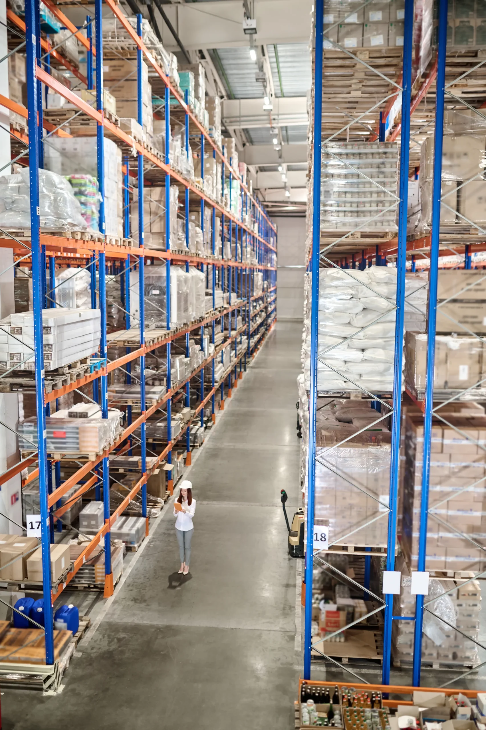 large-warehouse-woman-white-protective-helmet-with-tablet-standing-large-industrial-warehouse